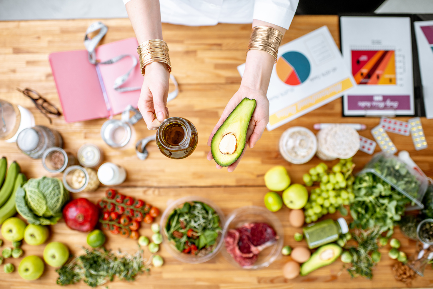 Dietitian Holding Avocado and Olive Oil